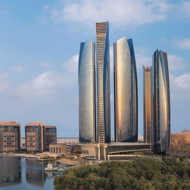 Three interconnected towers of Etihad Towers, a landmark skyscraper complex in Abu Dhabi, UAE.