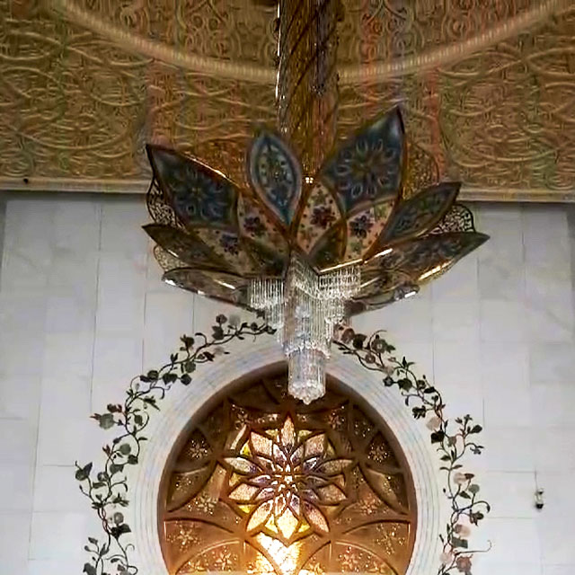 A beautiful, intricately designed chandelier adorns the interior of the Sheikh Zayed Grand Mosque in Abu Dhabi.