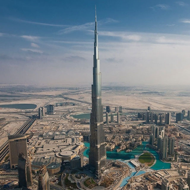 Burj Khalifa, the world's tallest building, soaring above the Dubai skyline, with other skyscrapers appearing miniature in comparison.