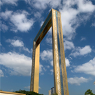 Close-up view of the Dubai Frame's golden facade, a rectangular structure inspired by a picture frame, set against a backdrop of blue sky.