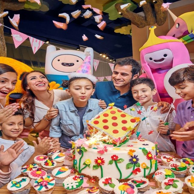 Happy family celebrating a birthday with fun and excitement at IMG Worlds of Adventure