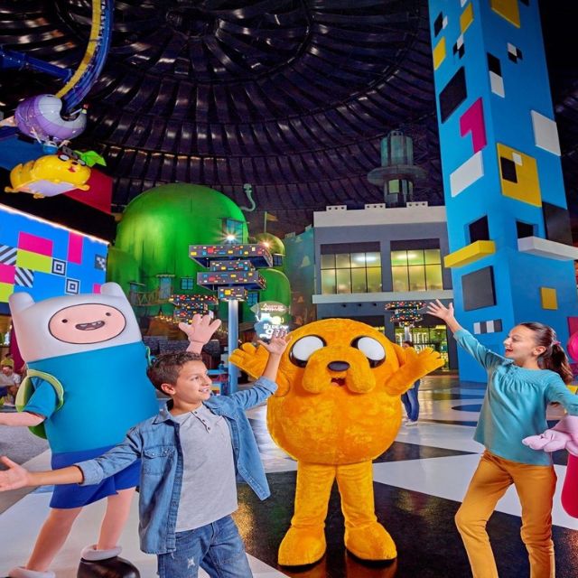 Excited children posing with the beloved Adventure Time characters Finn and Jake at IMG Worlds of Adventure