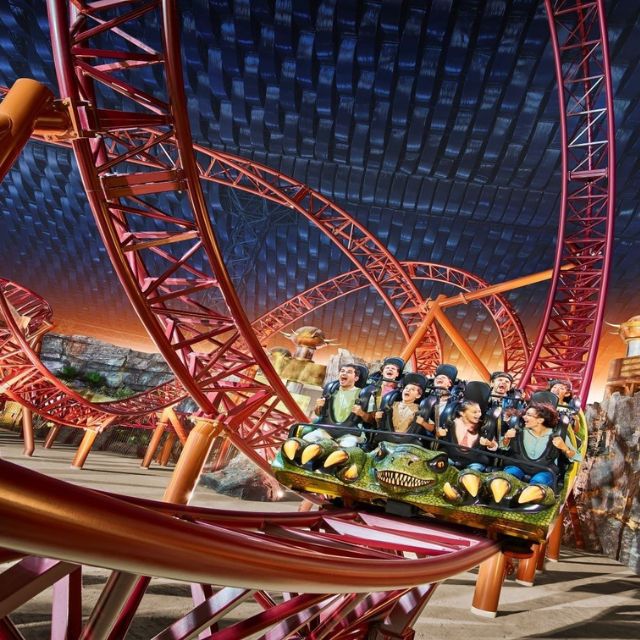A family and couple experiencing the excitement of the Predator rollercoaster at IMG Worlds of Adventure