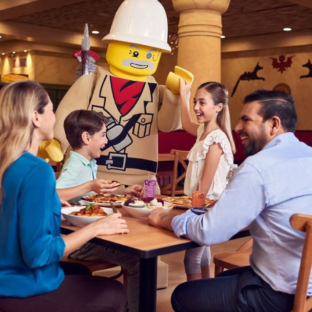 Happy family enjoying a delicious meal at Caesar's Pizza & Pasta Buffet in LEGOLAND Dubai