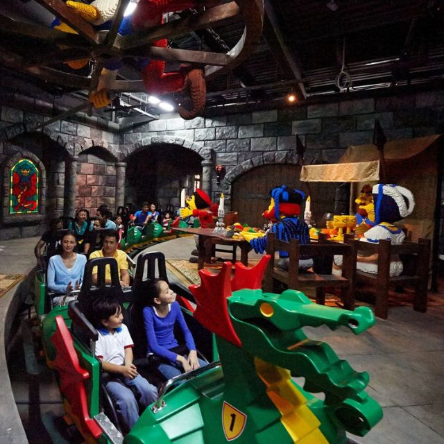 Excited family exploring the thrilling Dragon ride at LEGOLAND Dubai