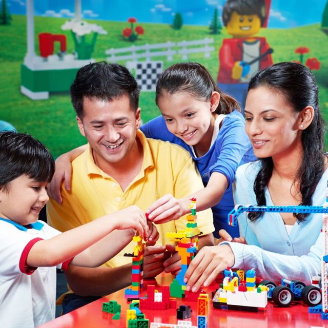 A family engaged in creative LEGO building at the LEGO Master Academy in LEGOLAND Dubai