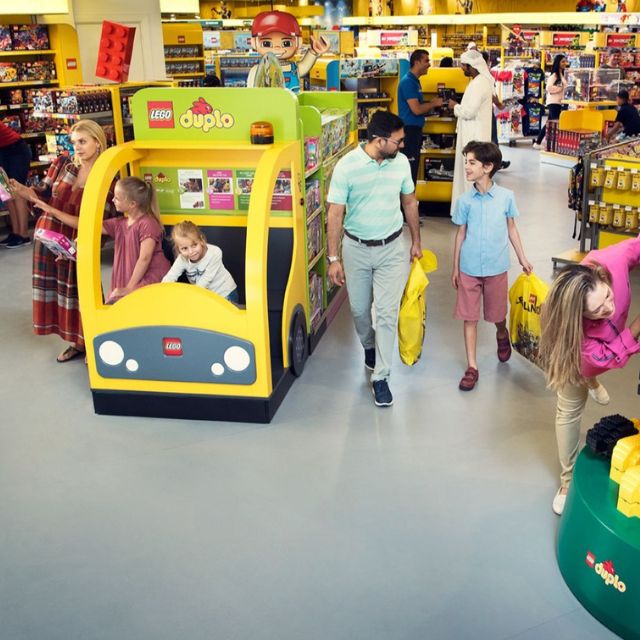 A family enjoying shopping for LEGO sets at the LEGOLAND store