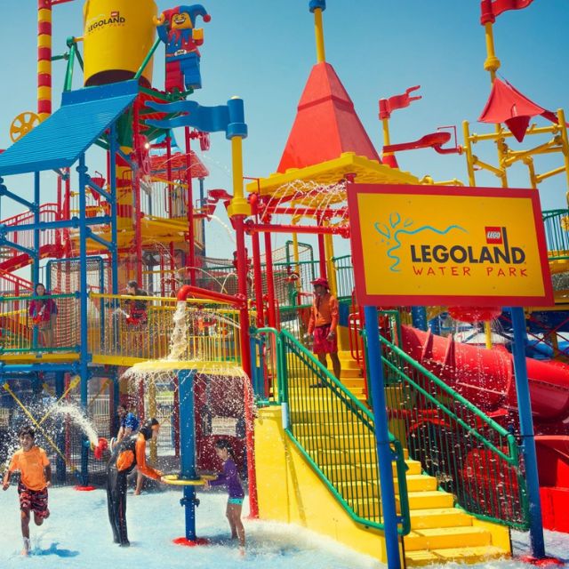 Excited children splashing and playing in the Joker Soaker water play area at LEGOLAND Water Park