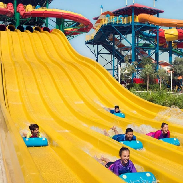 Happy family enjoying a thrilling ride down the mat slides at Lego Slide Racer, LEGOLAND Water Park
