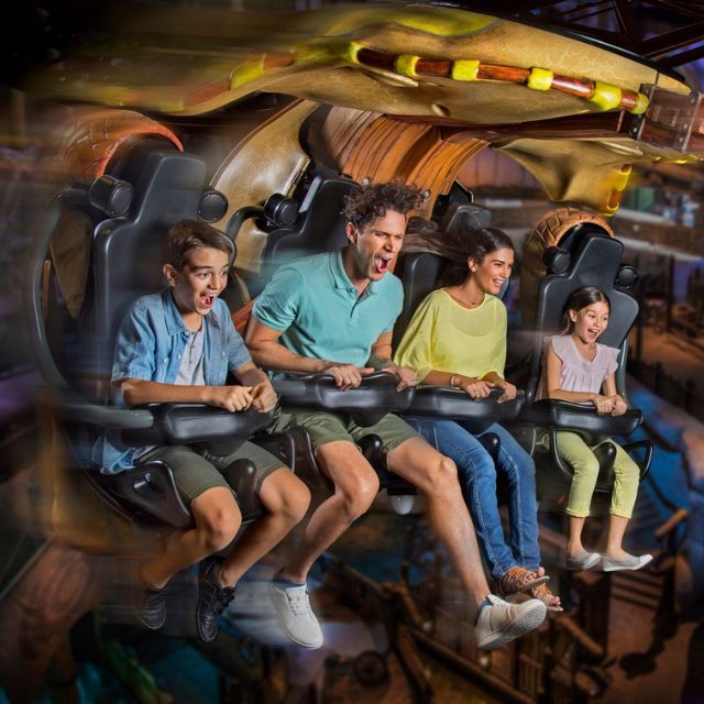 Family soaring through the skies on the thrilling Dragon Gliders ride at How to Train Your Dragon: The Live Show at Motiongate Dubai