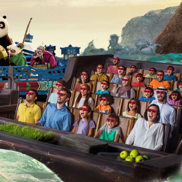 Families and couples immersed in the thrilling Kung Fu Panda world, wearing 3D glasses for the Unstoppable Awesomeness ride at Motiongate Dubai
