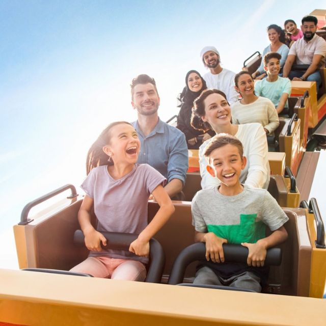 Family embarking on a magical adventure through Smurf Village, including the thrilling Smurf Village Express ride at Motiongate Dubai
