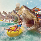 Thrilling water adventure: Father and daughter exiting the snake's mouth on Slither's Slides at Yas Waterworld Abu Dhabi
