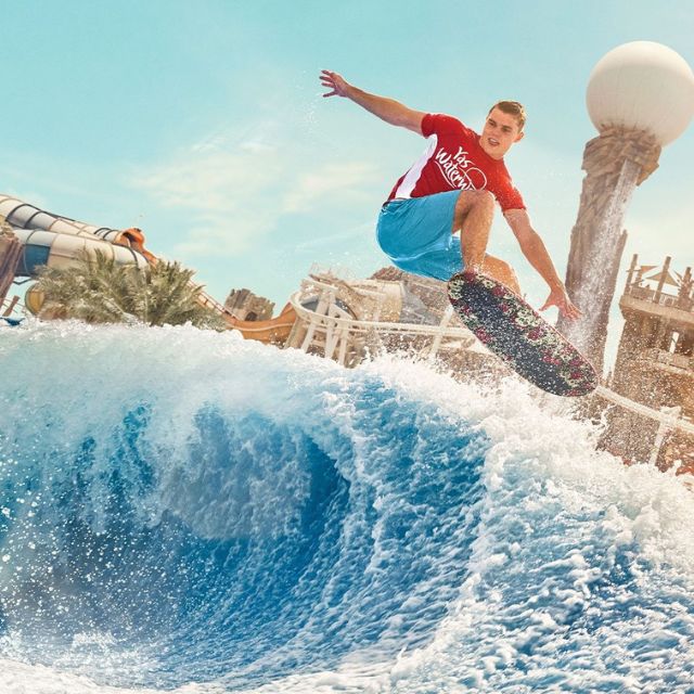 Thrilling wave experience: Adult surfing the Bubbles Barrel at Yas Waterworld Abu Dhabi